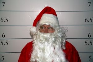 Santa dealing with an arrest booking photo after being stopped by police in Tucson Arizona